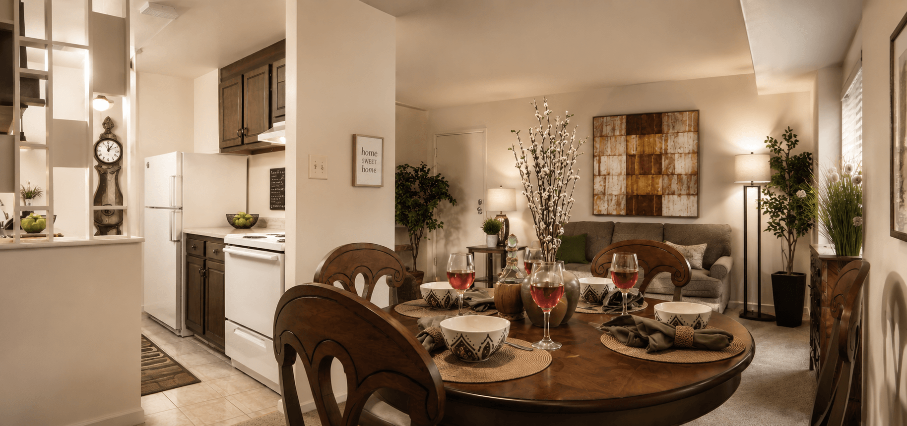 A modern dining room with a wooden table set for a meal.